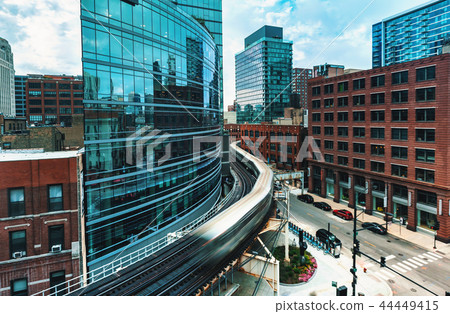 Elevated train curving through Chicago 44449415