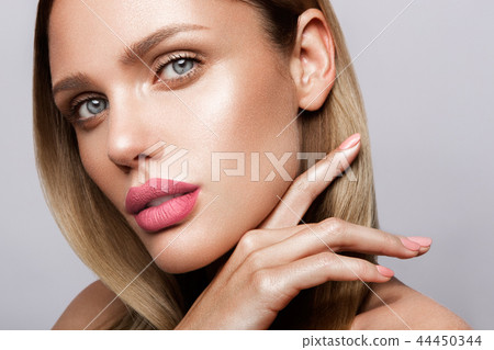 Beautiful young model with pink lips. Nude manicure 44450344