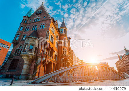 Metal arch bridge and old red bricks building in the Speicherstadt warehouse district of Hamburg Metal arch bridge and old red bricks building in the Speicherstadt warehouse district of Hamburg 44450979
