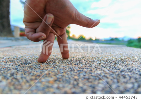 hand finger walking on walkway stone  44453745