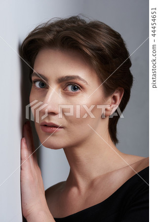 Woman listen through wall Woman listen through wall 44454651
