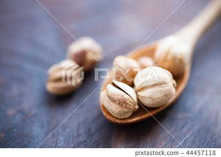 White cardamon on wooden spoon,herb and spice White cardamon on wooden spoon,herb and spice 44457118