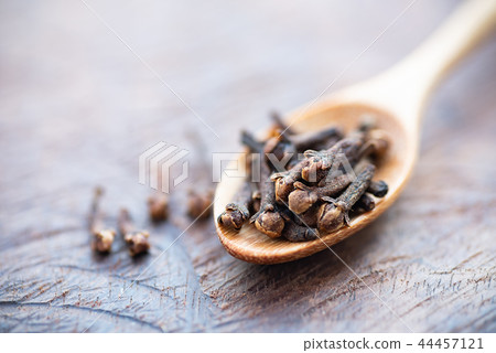 Dried cloves on wooden spoon, herb and spice Dried cloves on wooden spoon, herb and spice 44457121