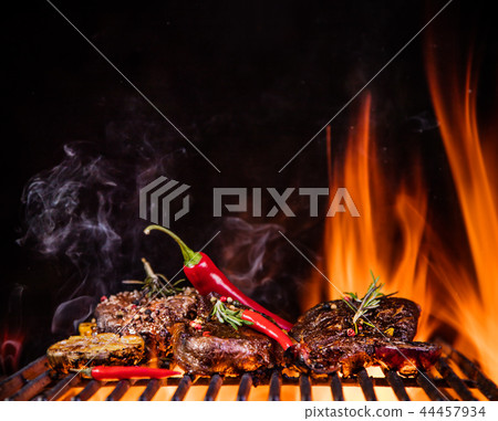 Beef steaks on the grill with flames Beef steaks on the grill with flames 44457934