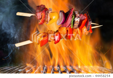 BBQ Flaming Charcoal Cast Iron grill with tasty skewers. BBQ Flaming Charcoal Cast Iron grill with tasty skewers. 44458254