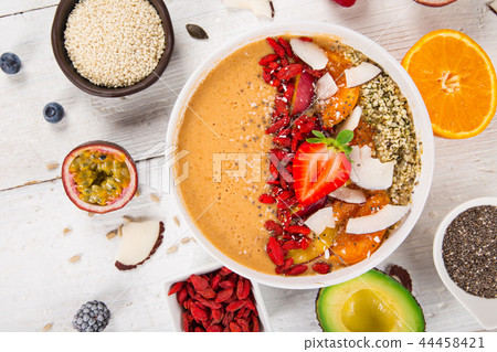 Smoothie bowl with fresh berries, nuts, seeds, fruit and vegetables. Smoothie bowl with fresh berries, nuts, seeds, fruit and vegetables. 44458421