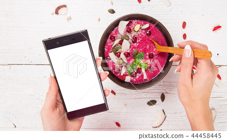Smoothie bowl with modern cell phone. 44458445