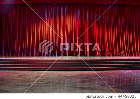 Red curtains and wooden stage. 44459323
