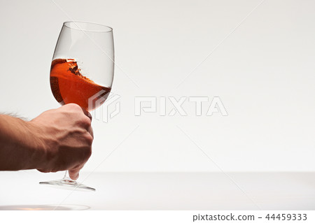 Hand take red wine glass 44459333