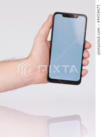 Hand holding smartphone with notch 44459475