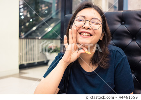 Close up of young Asian woman in the restaurant. Close up of young Asian woman in the restaurant. 44461559