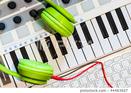green headphone on keyboard for music concept green headphone on keyboard for music concept 44463687