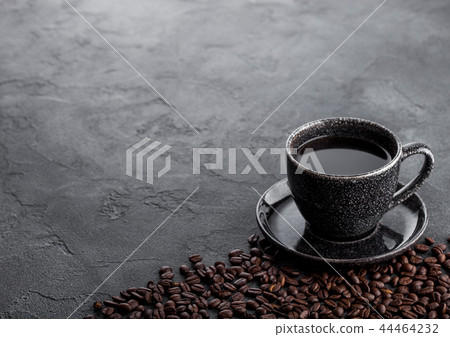 Black coffee cup with saucer and coffee beans 44464232