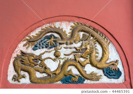 Dragon fresco bas-relief on a red wall in China Dragon fresco bas-relief on a red wall in China 44465391