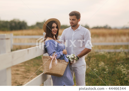 Happy family is waiting for baby. Pregnant woman and her husband in nature Happy family is waiting for baby. Pregnant woman and her husband in nature 44466344