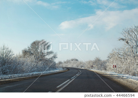 Winter road ahead. Frozen landscape, empty highway 44466594