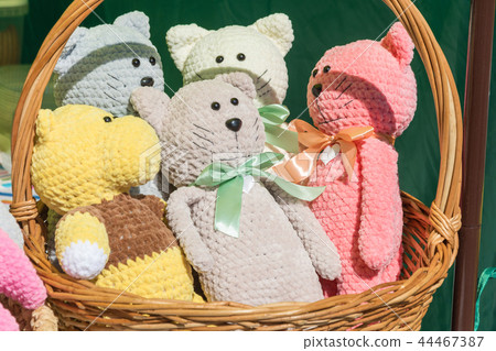 A soft toy in a large basket. 44467387
