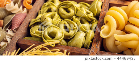 Assorted colorful italian pasta in wooden box Assorted colorful italian pasta in wooden box 44469453