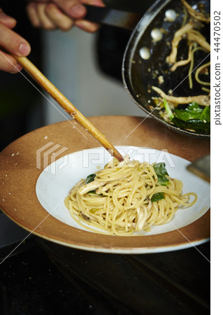 Men making oyster mushrooms and spinach pasta Men making oyster mushrooms and spinach pasta 44470502