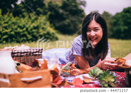 Portrait of beautiful woman enjoy picnic in a park Portrait of beautiful woman enjoy picnic in a park 44471157