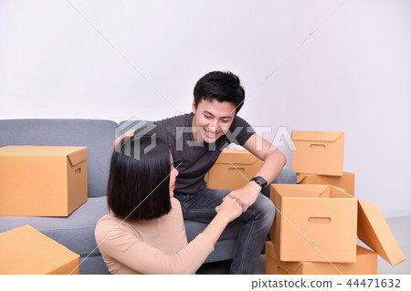 Moving house Concept. Asian young man is carrying his belongings Moving house Concept. Asian young man is carrying his belongings 44471632
