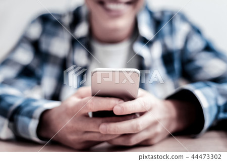 Close up of young person holding modern smartphone 44473302