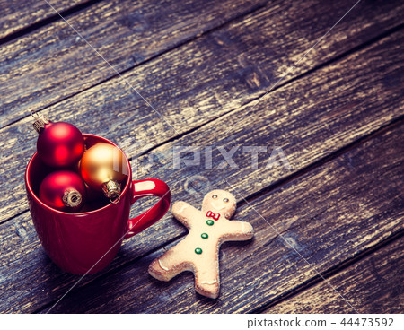 Cup with christmas baubles and gingerbread man 44473592