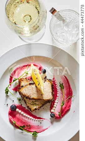 White fish with lemon on white plate, selective focus White fish with lemon on white plate, selective focus 44473778