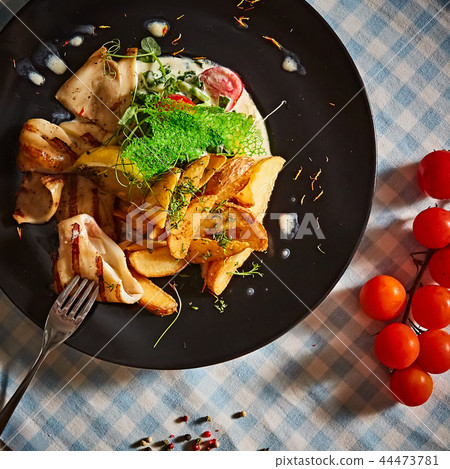The grilled squid with salad. Shallow dof. 44473781