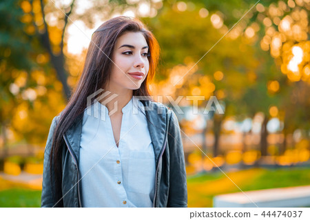 Portrait of young happy business woman in the city. Beautiful caucasian student girl in white sexy 44474037