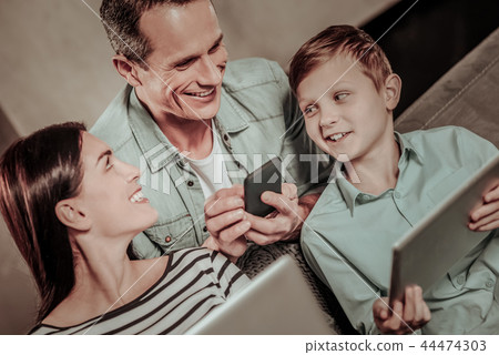 Positive delighted boy looking at his parents Positive delighted boy looking at his parents 44474303