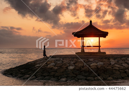 Woman with sunshine in pavilion on jetty Woman with sunshine in pavilion on jetty 44475662