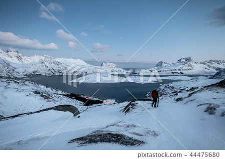 Climber lost on snowy mountain with sky Climber lost on snowy mountain with sky 44475680
