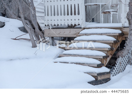 Snow covered on wooden stairs house 44475685
