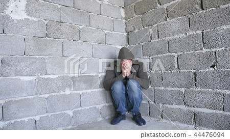 desperate unhappy man by the wall. the concept of stress and hopeless 44476094