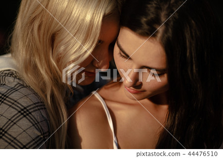 Close up of lesbian couple embracing Close up of lesbian couple embracing 44476510