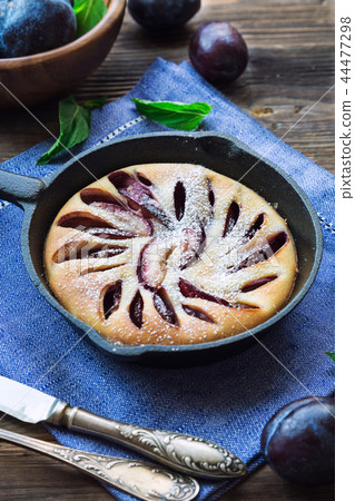 Fresh homemade plum cake in iron skillet 44477298