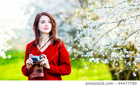 portrait of young woman with camera 44477700