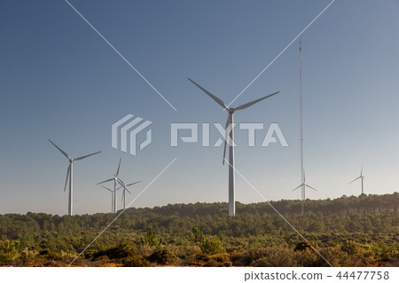 A wind turbine over plain land A wind turbine over plain land 44477758