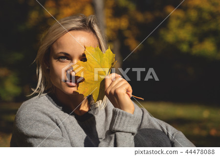 Young woman lying in autumn park with leafs. Young woman lying in autumn park with leafs. 44478088