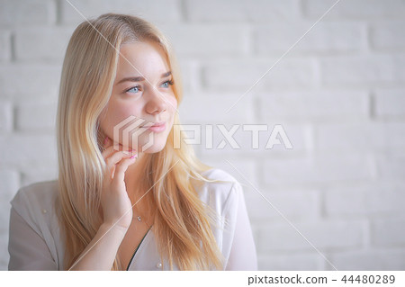 cute blond young adult / portrait of an adult beautiful girl model with blond hair in a happy image cute blond young adult / portrait of an adult beautiful girl model with blond hair in a happy image 44480289