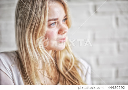 cute blond young adult / portrait of an adult beautiful girl model with blond hair in a happy image cute blond young adult / portrait of an adult beautiful girl model with blond hair in a happy image 44480292