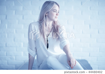 cute blond young adult / portrait of an adult beautiful girl model with blond hair in a happy image cute blond young adult / portrait of an adult beautiful girl model with blond hair in a happy image 44480402