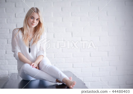 cute blond young adult / portrait of an adult beautiful girl model with blond hair in a happy image cute blond young adult / portrait of an adult beautiful girl model with blond hair in a happy image 44480403