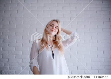 cute blond young adult / portrait of an adult beautiful girl model with blond hair in a happy image cute blond young adult / portrait of an adult beautiful girl model with blond hair in a happy image 44480436
