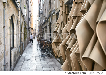 Old narrow street with stone houses in Dubrovnik in Croatia Old narrow street with stone houses in Dubrovnik in Croatia 44483534