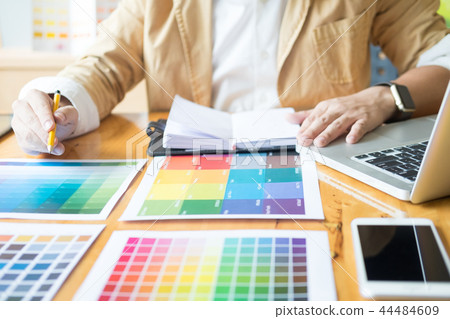 Creative Graphic designer at work. Color swatch samples pantone 44484609