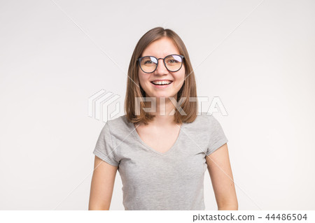 Young beautiful funny woman in glasses over white background Young beautiful funny woman in glasses over white background 44486504