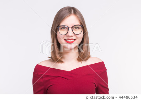 Fashion, emotions, people concept - young happy woman in glasses with red lips smiling over white 44486534