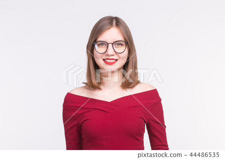 Beautiful young woman in red blouse with spectacles and bright makeup on white background Beautiful young woman in red blouse with spectacles and bright makeup on white background 44486535